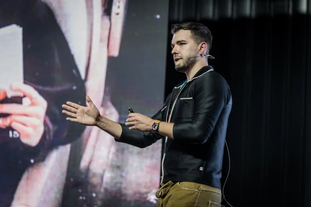 Mateusz Mach speaking about blockchain and on-chain finance engineering